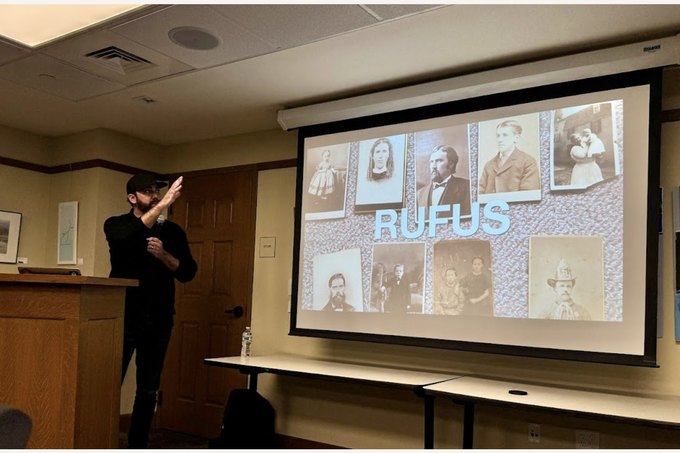 Erich giving the RUFUS talk, the family photographs projected on the screen.