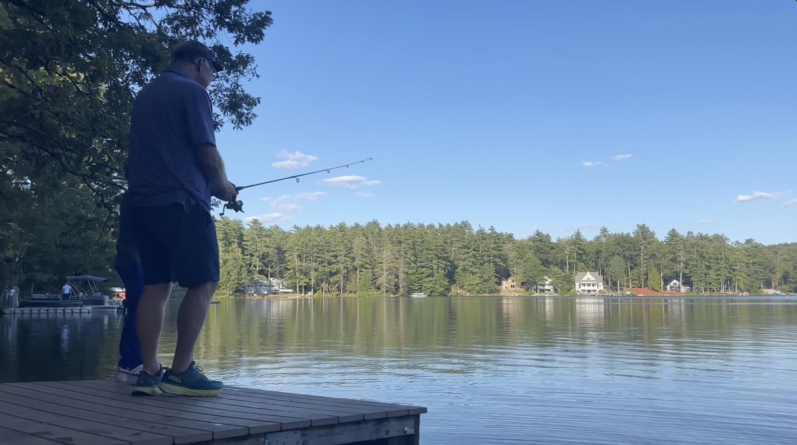 Test 02, original: fishing off a dock on a calm lake